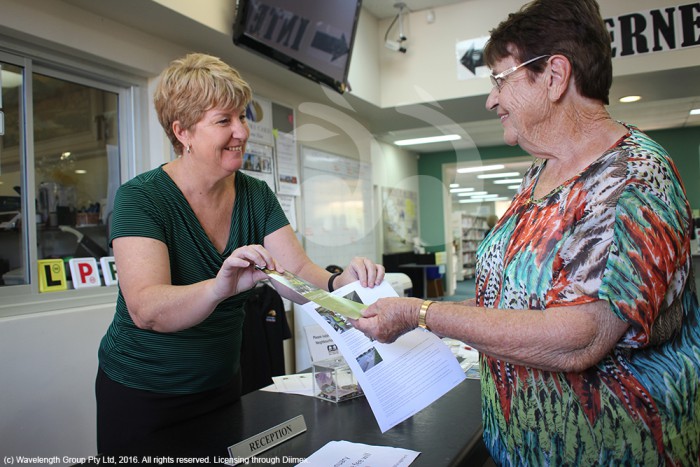 Lee Watts, manager of the Scone Neighbourhood Centre giving Shirley Harris of Toolooganvale, Dartbrook a printed copy of a scone.com.au news story