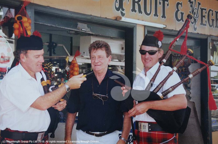 Closing of the store: Daryl McInnes (centre), the day his fruit and vegetable shop closed in 1998, with David Noonan and Mark Lawrance playing the bagpipes.
