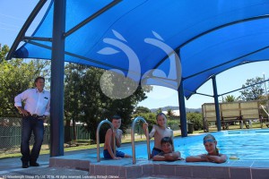 Wayne Bedggood, Mayor of the Upper Hunter Shire Council and Blandford Public School students Angus Speck, 10, Oliver Cornall, 10, Jack Teague, 12, and Charlotte Brooks, 12, cool down under the new shade shelter at the Murrurundi and District War Memorial Swimming Pool.