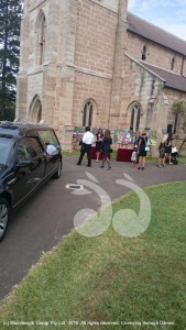 Mourners view the beautiful images of Olivia as they enter the funeral service at St Jude's in Randwick