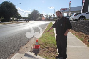 Jake Gorst points to the spot where four cars have lost control, crashed into a light pole and careered onto the footpath in less than 12 months.