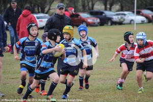 Under 8's player Rory Moore makes a break against Walcha, supported by team mates (L-R) Archie Adkins, Andrew Crowther and Hamish Davidson.