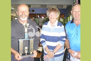 Emil Battista presented with the Ossie Miles trophy by Judy Miles and son Jimmy Miles at Muswellbrook Golf Club today.