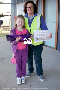 St Joseph's Merriwa principal Helen Whale awarded Bethany Wightman her prize for winning the fete andd campdraft colouring in competition. Photo: Tash Holden.