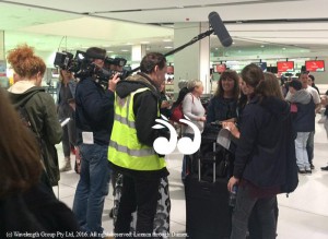 Media interviewing Australian team members at the airport.