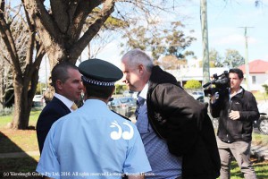 Detective Sergeant Ian Wright, Inspector Guy Guiana with back to camera and NSW police media advisor Shaun Fewings discussing the case at the media conference.