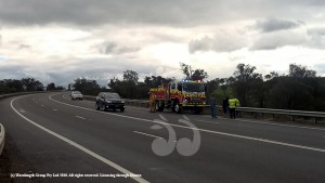 Fire services and police on the site of an accident on the New England Highway after a single car collided with the guard rail.