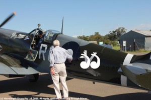 WWII pilot Lysle Roberts pauses for a moment with the spitfire before it flew back to Temora.