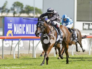 Jeff Lloyd riding Houtzin over the line in the 2 year old Magic Millions on the Gold Coast.