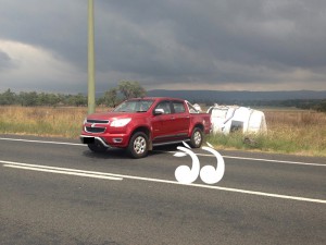 A red Holden Colorado which was in an accident on the New England Highway.