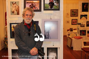 Roger Skinner inspecting the entries for this year's Scone Photographic Exhibition.