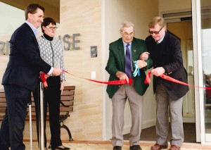 Jim Clark OAM cutting the ribbon at the openign of Strathearn House, assissted by past Strathearn board president, Bill Howie. Matthew Downie and Kate Mailer to the left.