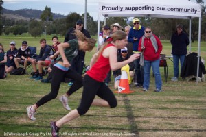 Mersadies Cadalbert crossing the finish line to claim Queen of the Track at the St Joseph's athletics carnival, with Tyler Brown close behind.