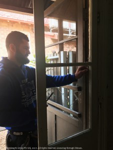 Jake Bailey fixing the kitchen door at Asser House Cafe after the break-in.