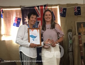 Ambassador Catherine DeVrye presents Caitlin Porter with the Young Achiever of the Year award.