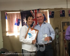 Robert Tindall receives the Achiever of the Year award from Ambassador Catherine DeVrye