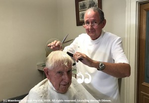 Chris Winter cutting his uncle's hair Fred Winter.